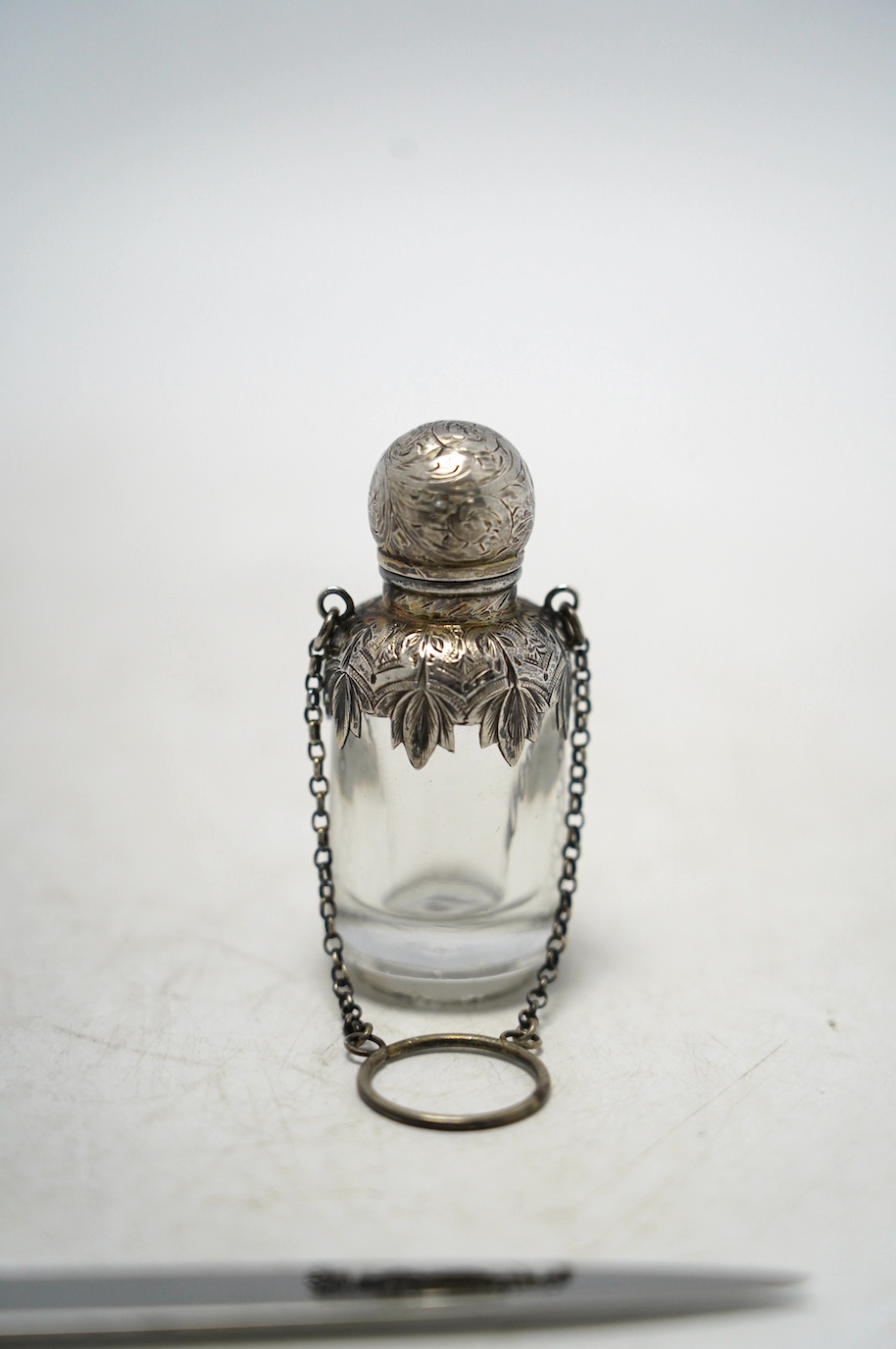 A late Victorian novelty propelling pencil modelled as two coins mounted on a central boss, diameter 24mm, together with a small late Victorian silver whistle, mounted scent flask, silver thimble and a modern Asprey silv